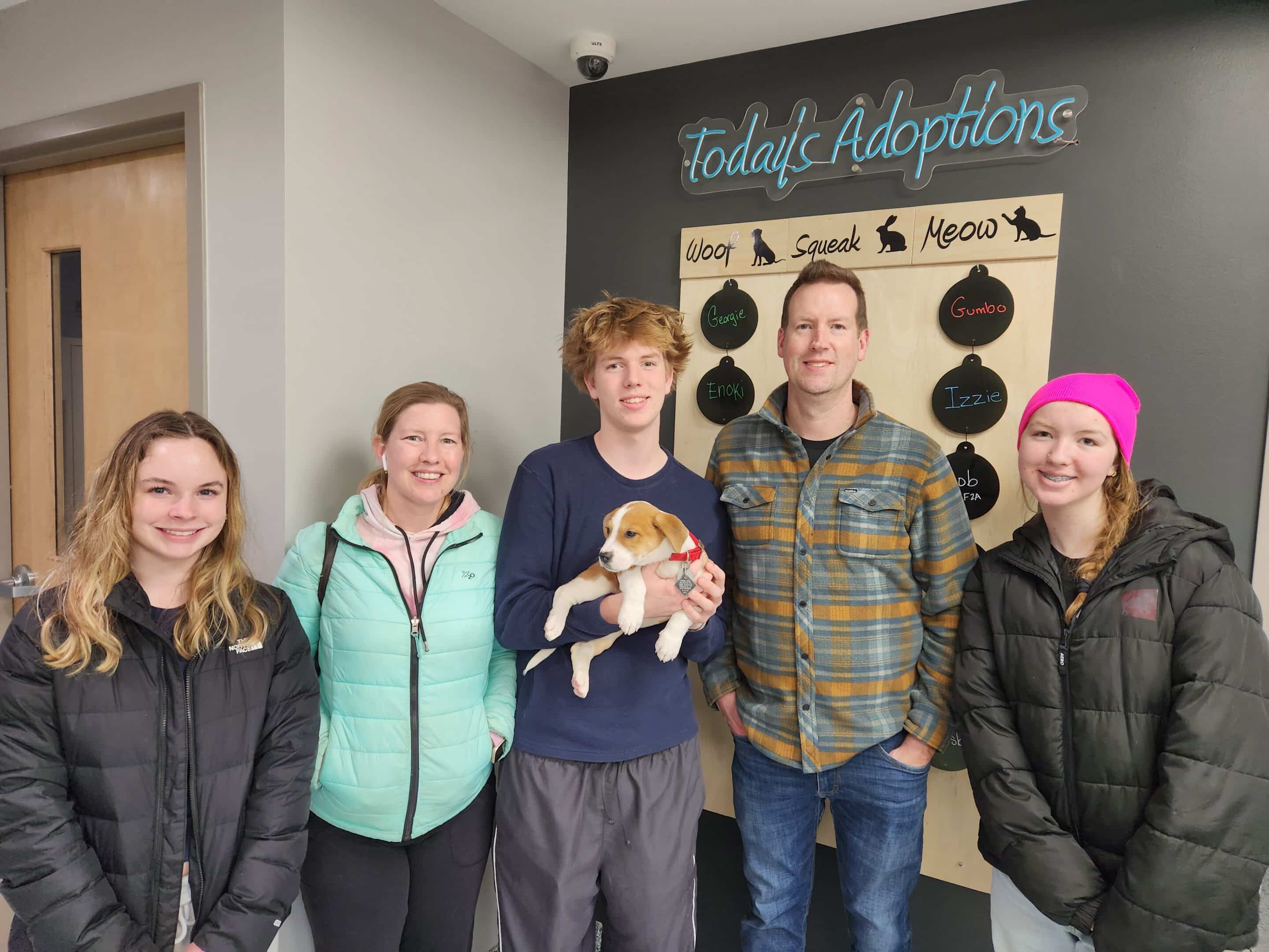 Family posing with their new puppy